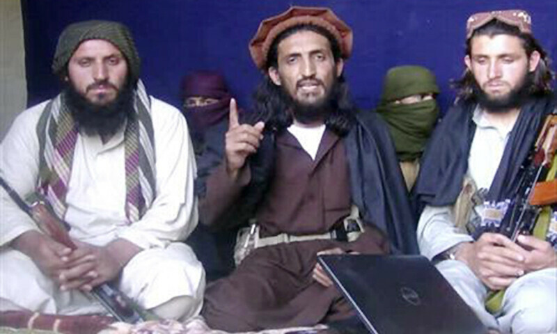 <p>Omar Khalid Khorasani is seen in the centre during an interview in Mohmand tribal region on June 2, 2011. —Reuters/File</p>