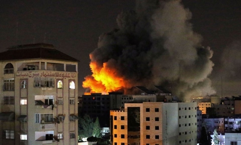 Smoke rises from a tower after it was hit by Israeli air strikes amid a flare-up of Israeli-Palestinian violence, in Gaza City, May 12. — Reuters