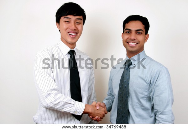 indian-chinese-businessman-shaking-hands-600w-34769488.jpg