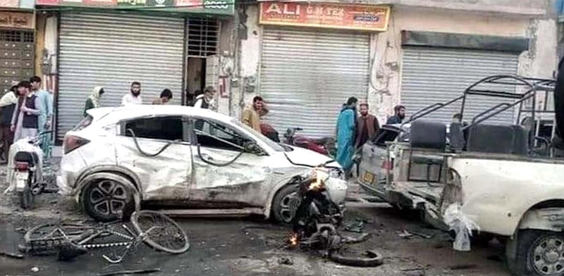  Passersby look at vehicles damaged in the blast that targeted a police van, near Eastern Bypass in Quetta, on Wednesday.—INP 