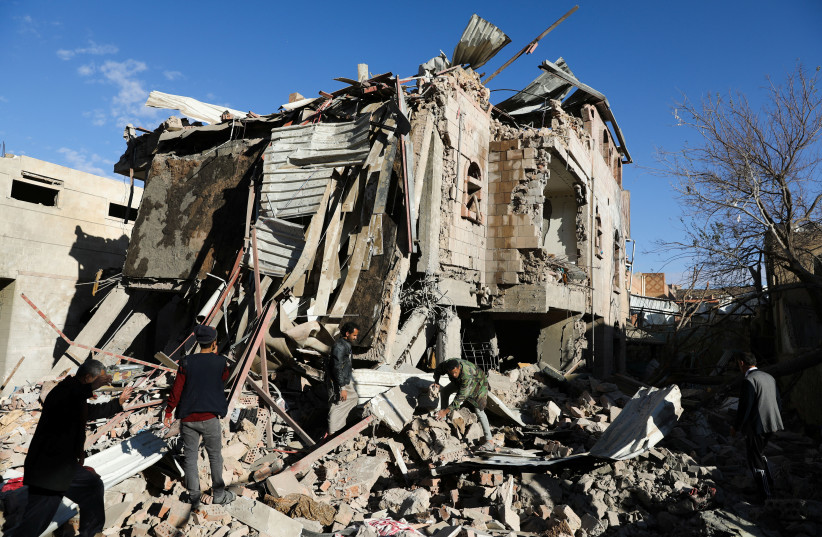  Rescuers remove debris at the site of Saudi-led air strikes in Sanaa, Yemen, January 18, 2022.  (credit: REUTERS/KHALED ABDULLAH)