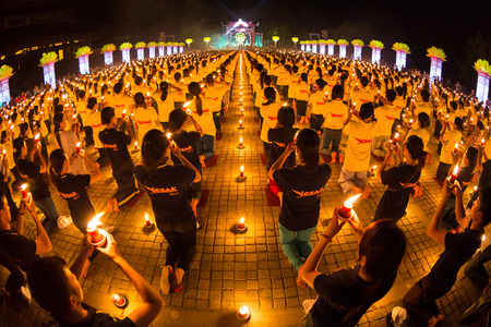 30371932-ninhbinh-vietnam--may-05--vesak-day-traditional-buddhist-monks-are-lighting-candles-for-religious-ce.jpg