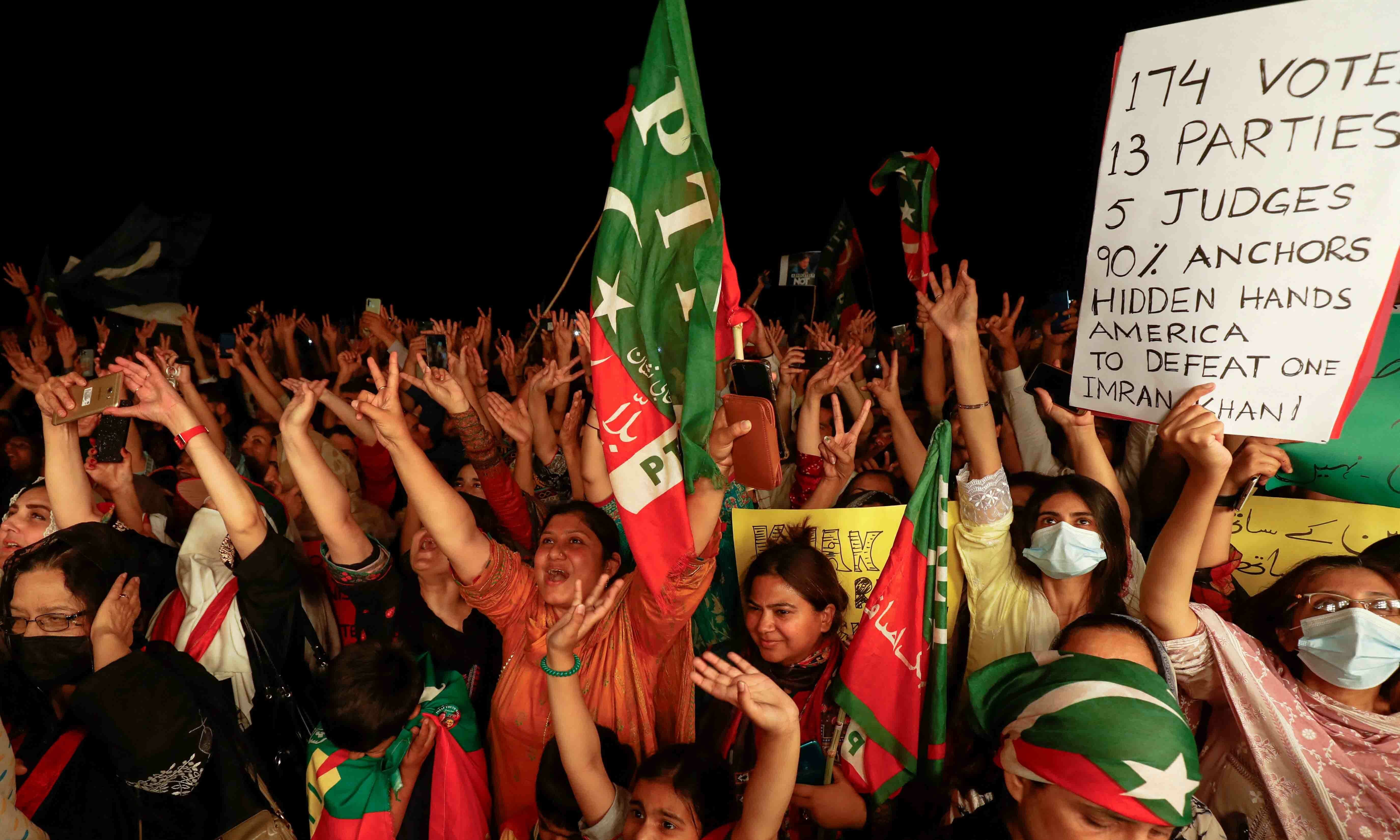 PTI supporters raise their hands during a rally in support of former prime minister Imran Khan in Islamabad on April 10. — Reuters