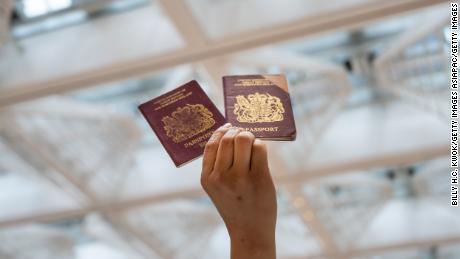 A pro-democracy protester holds a British passport during a June 2020 rally in Hong Kong.