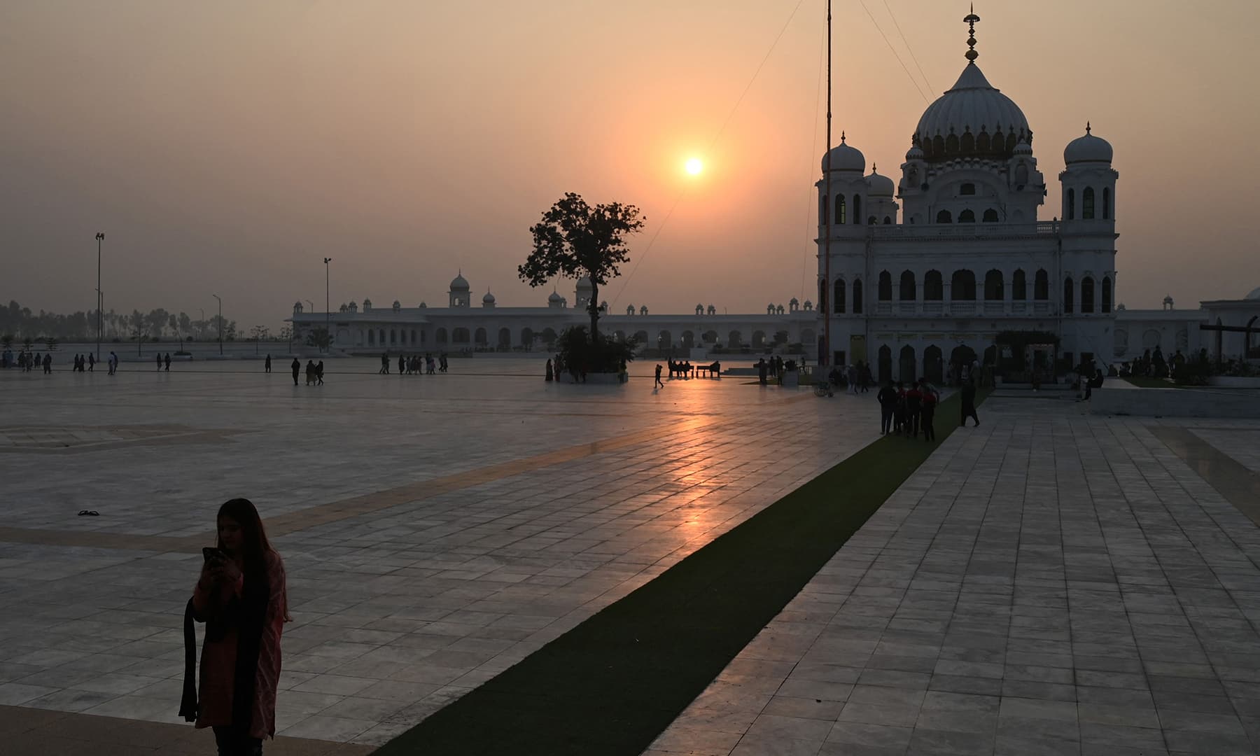 Sikh pilgrims arrive to take part in a religious ritual on the eve of the birth anniversary of Guru Nanak, at the Gurdwara Darbar Sahib in Kartarpur on Nov 18. — AFP