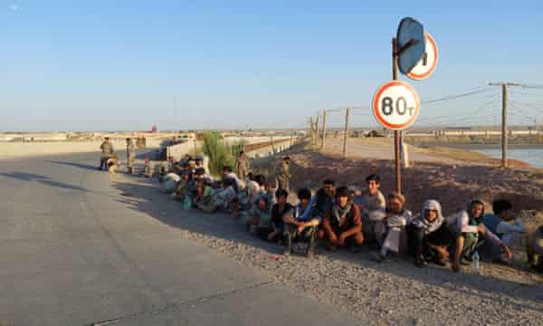 Afghanistan’s government soldiers sit at a bridge next to Tajikistan-Afghanistan border in Tajikistan, after they were forced to retreat through of the Panj frontier detachment into the territory of the Republic of Tajikistan on Tuesday, June 22, 2021.