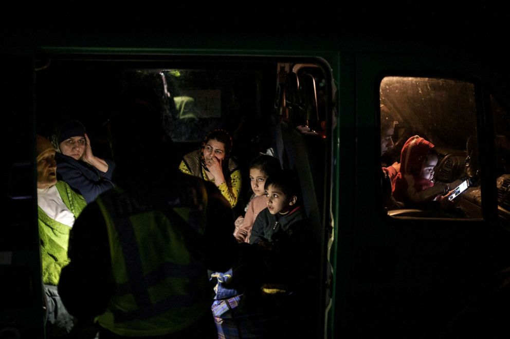 PHOTO: A police officer checks documents of a family arriving from Mariupol at a refugee center in Zaporizhia, Ukraine, on April 1, 2022.