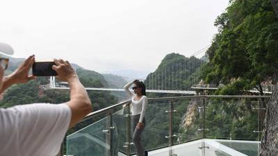 Visitors on the walkway section of the Bach Long glass bridge.