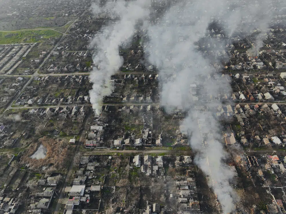 Smoke billows after Russian attacks in the outskirts of Bakhmut, Ukraine, Tuesday, Dec. 27, 2022. (AP Photo/Libkos)