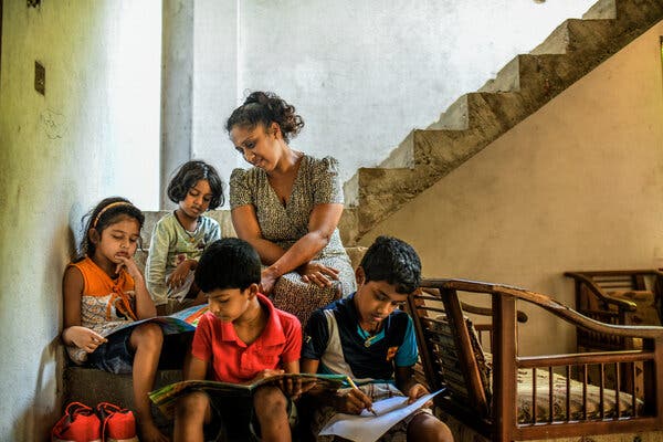 Sandamali Purnima with her children at her unfinished home in the suburbs of Colombo, in March.