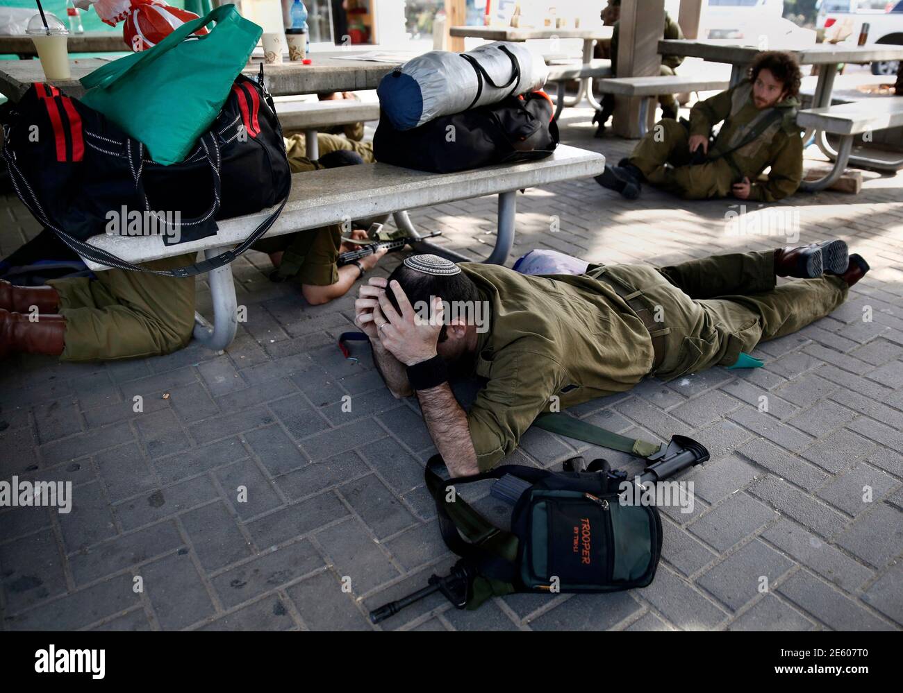 israeli-soldiers-take-cover-as-a-siren-sounds-warning-of-incoming-rockets-outside-a-coffee-shop-at-kibbutz-yad-mordechai-near-the-border-with-northern-gaza-november-21-2012-israeli-air-strikes-shook-the-gaza-strip-and-palestinian-rockets-struck-across-the-border-as-us-secretary-of-state-hillary-clinton-held-talks-in-jerusalem-in-the-early-hours-of-wednesday-seeking-a-truce-that-can-hold-back-israels-ground-troops-reutersyannis-behrakis-israel-tags-civil-unrest-military-politics-tpx-images-of-the-day-conflict-2E607T0.jpg