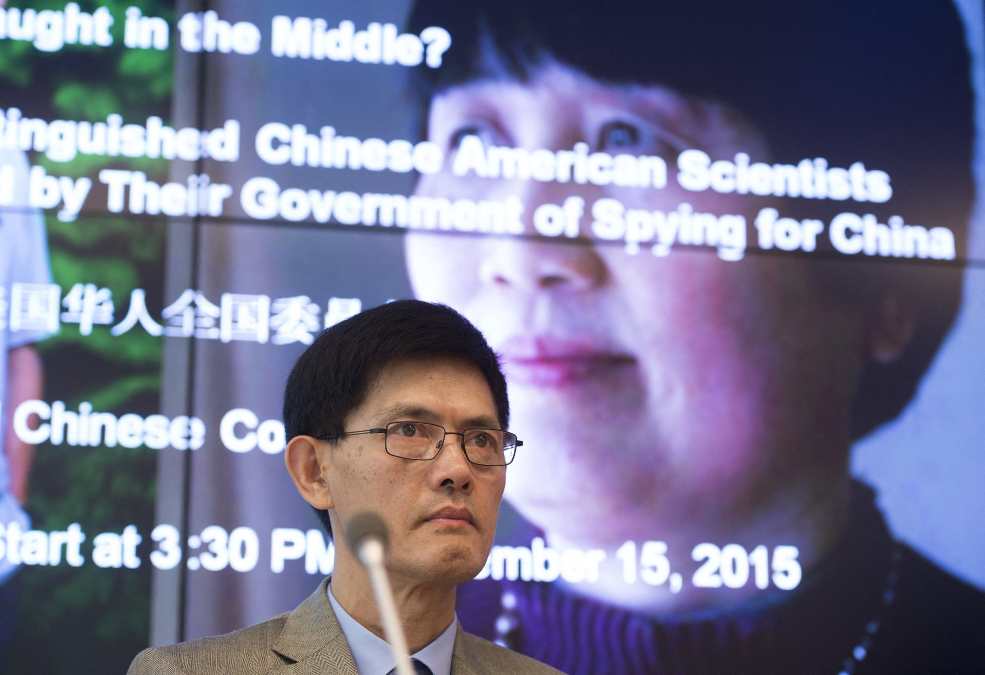 Xi Xiaoxing, a physicist, at a news conference in 2015 with a photograph of Chen behind him. Photo: AFP