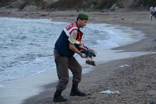 Officer-lifts-tragic-Aylan-Kurdi-3-from-the-sea-in-resort-of-Bordrum.jpg