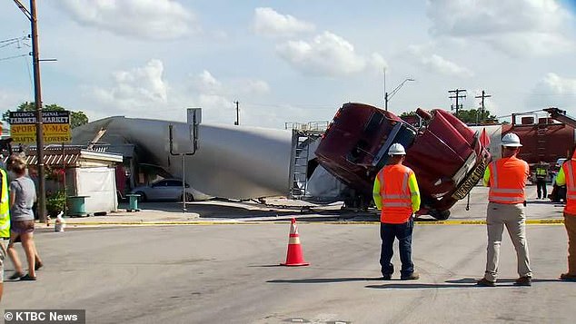 A semi truck carrying a wind turbine blade on Route 183 in Luling, Texas made impact with a speeding train and turned over after it was stuck on the tracks