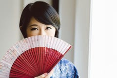 beautiful-woman-fan-portrait-japanese-looking-camera-47885007.jpg