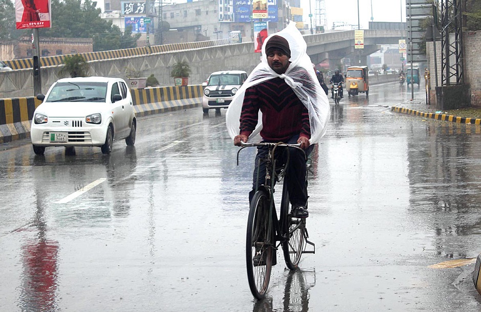 cyclist-on-the-way-under-the-cover-of-plastic-sheet-to-protect-from-rain-that-experienced-the-city.-app-1578382056.jpg