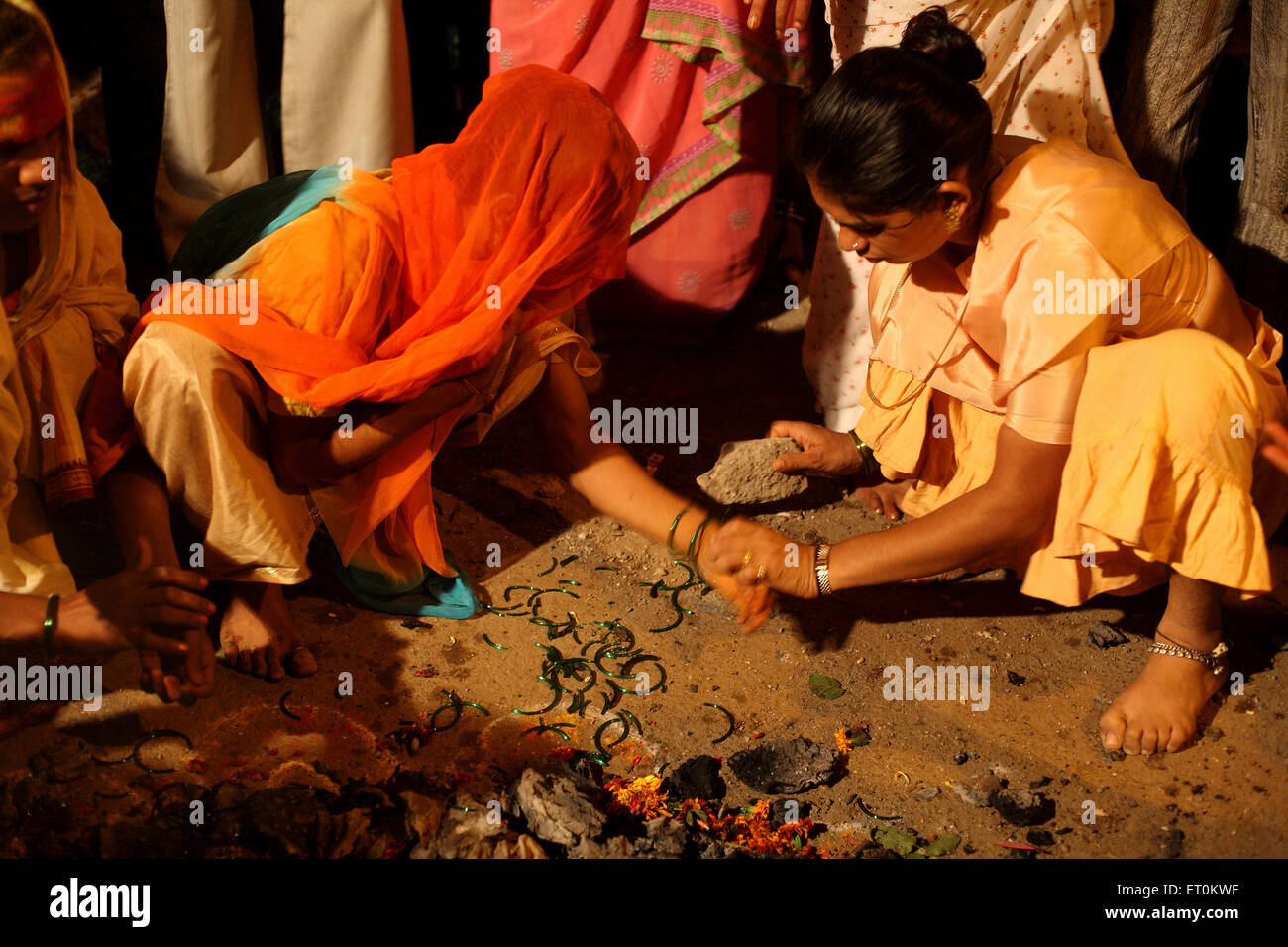 woman-breaking-green-bangles-as-mark-of-widowhood-after-wedding-of-ET0KWF.jpg