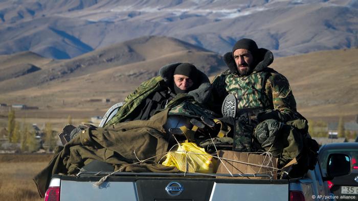 Armenian soliders sit in the back of a pick up at the Nagorno-Karabakh border