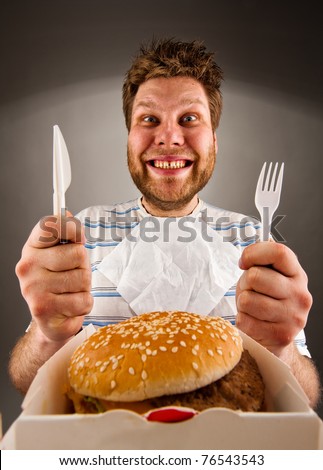 stock-photo-portrait-of-happy-man-with-knife-and-fork-ready-to-eat-burger-76543543.jpg