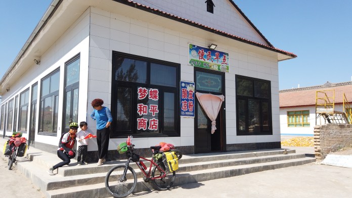 In 2014 there were only wooden structures along this road, now, we can stop for a meal in a store like this