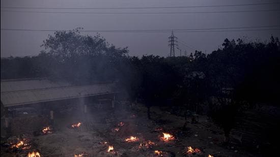 Funeral pyres of Covid-19 fatalities burn during a mass cremation at a crematorium in New Delhi, India, on Friday. (Bloomberg)
