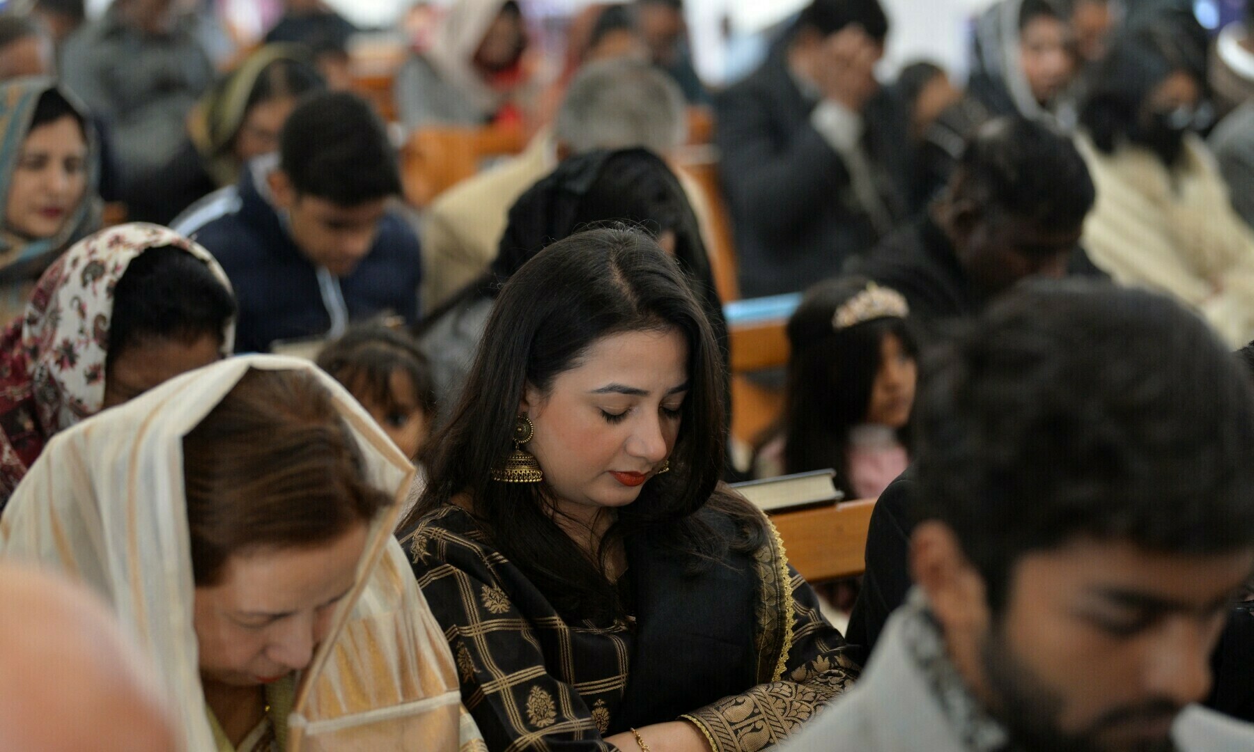 Christian devotees take part in a Christmas prayer at the Christ Church in Rawalpindi on December 25, 2022. — AFP