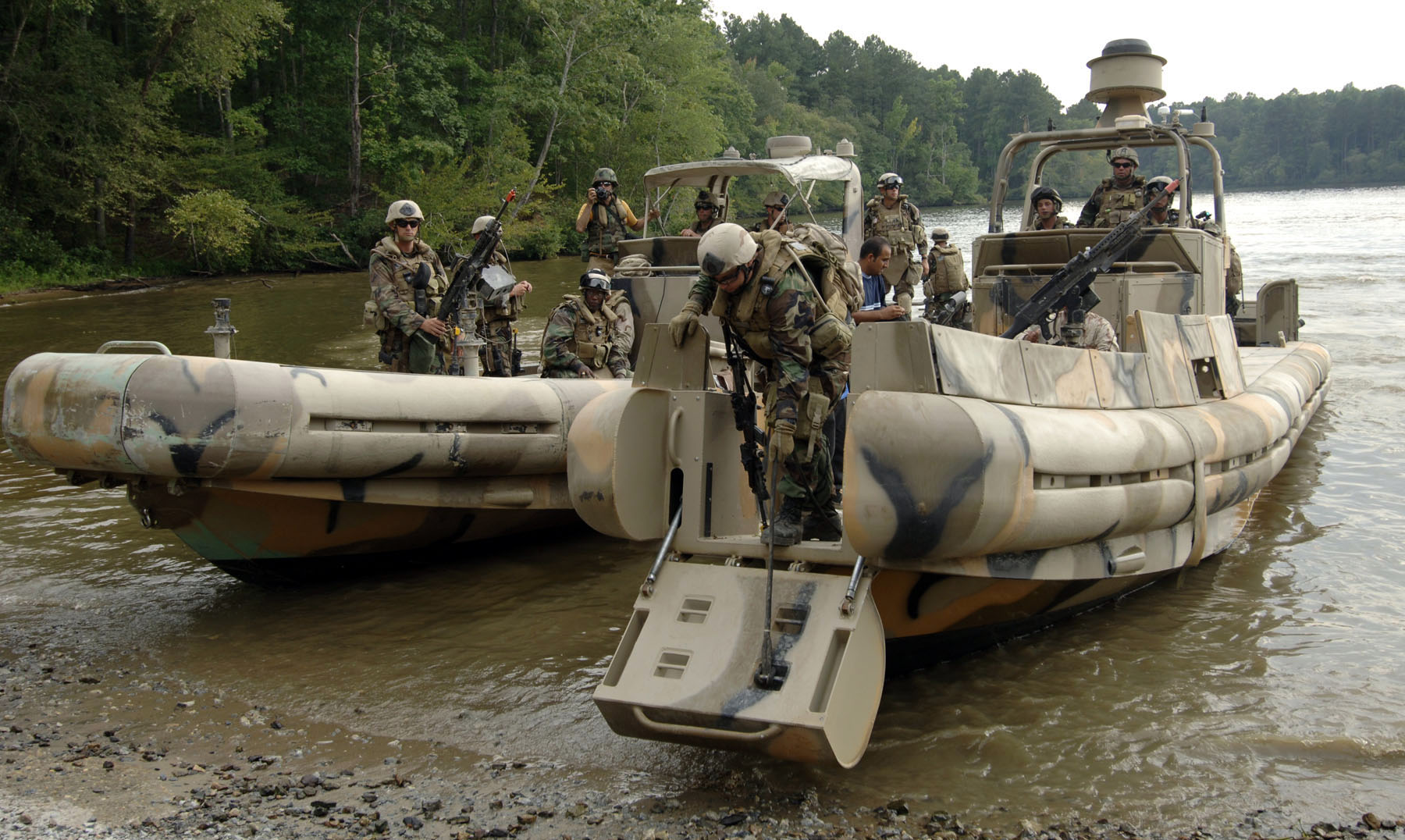 US_Navy_070910-N-6639M-043_Sailors_assigned_to_Riverine_Squadron_%28RIVRON%29_2_come_ashore_with_two_simulated_detainees_to_be_turned_over_to_Mobile_Security_Squadron_3%2C_Det._33%2C_during_COMET_2007.jpg