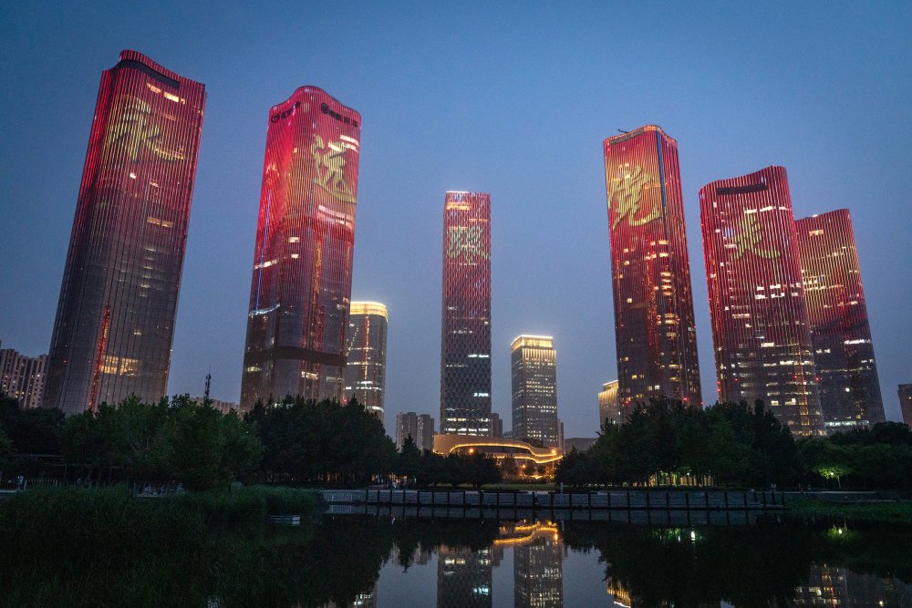 Chinese characters reading  Always follow the party  illuminate buildings during a light show marking the upcoming centenary of the Community Party in Beijing on June 26.