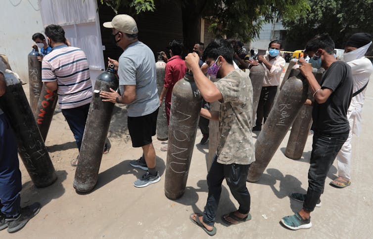 People queuing to get their oxygen tanks refilled, New Delhi, India, May 11 2021.