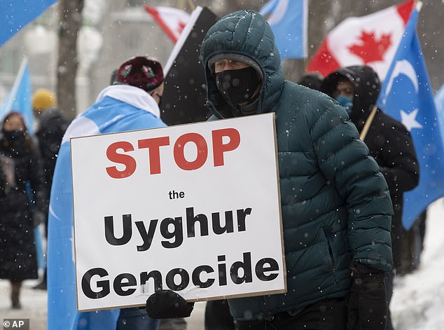 Protesters gather outside the Parliament buildings in Ottawa, Ontario, ahead of a motion calling on Canada to recognise China's actions against ethnic Muslim Uighurs as genocide