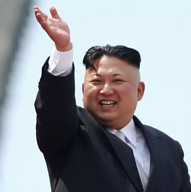 North-Korean-leader-Kim-Jong-Un-waves-to-people-attending-a-military-parade-marking-the-105th-birth.jpg