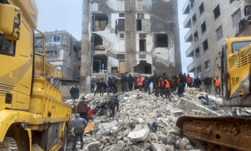<p>Rescuers search for survivors under the rubble of a collapsed building, following an earthquake in Hama, Syria on Feb 6. — Reuters</p>