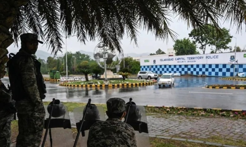 Paramilitary soldiers stand guard in front of the French Embassy in the Red Zone which was secured with shipping containers by the authorities to beef up security following violent anti-France protests, in Islamabad. — AFP