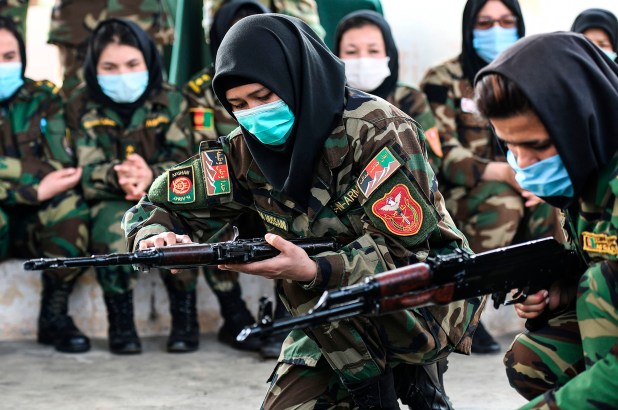 Afghan women cadets handle an AK-47 rifle during a training program at the Officers Training Academy in Chennai on February 18, 2021.