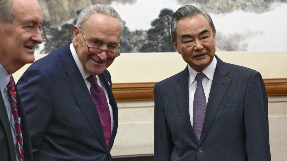 US Senate Majority Leader Chuck Schumer (C) and US Senate Mike Crapo (L) meet with Chinese Foreign Minister Wang Yi at the Diaoyutai Guest House in Beijing
