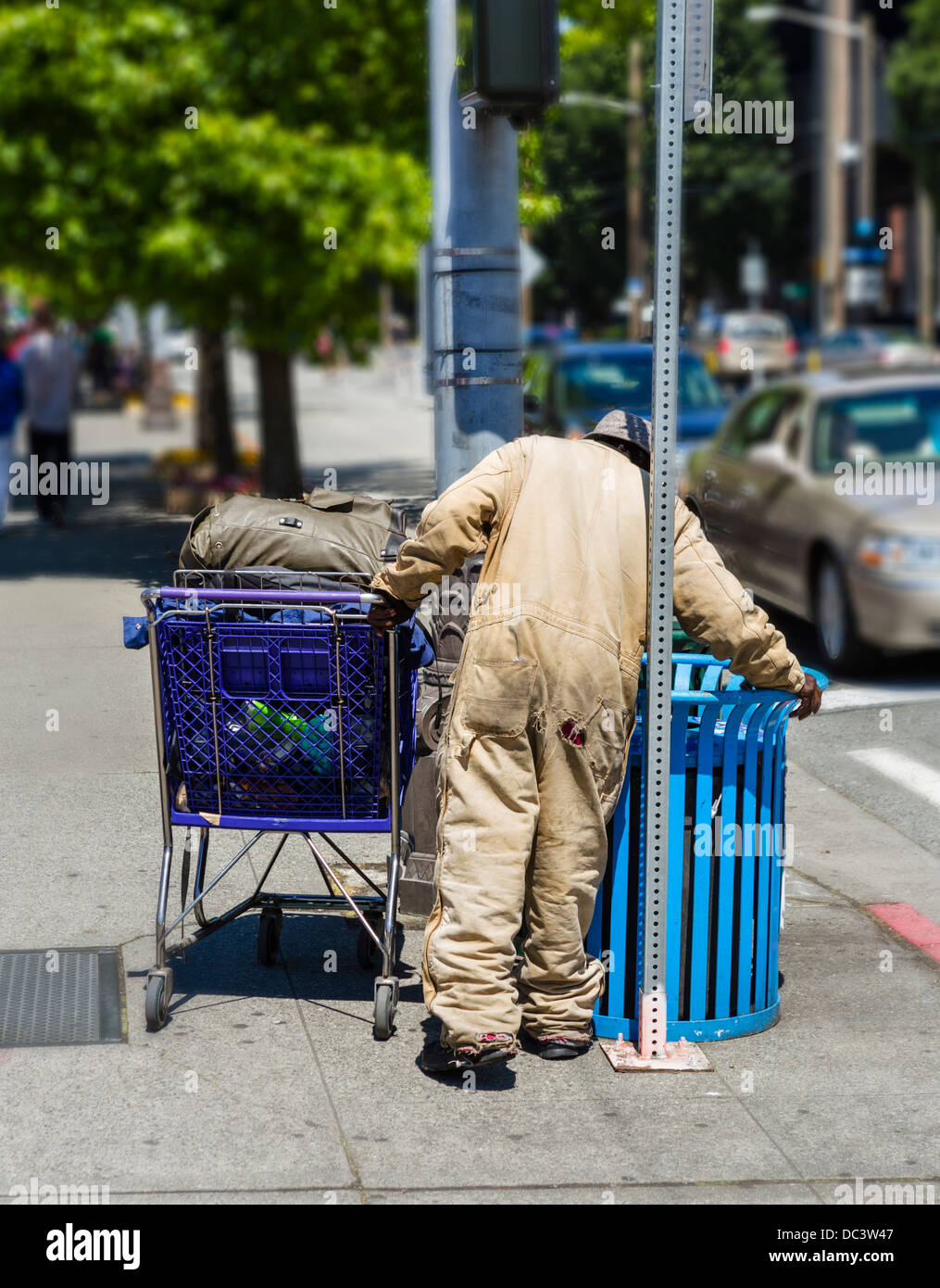 homeless-man-with-a-shopping-cart-scavenging-in-a-trash-can-seattle-DC3W47.jpg