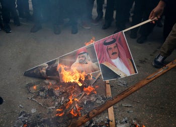 Angry Palestinian protesters set portraits of the king of Bahrain, prime minister of UAE and Oman's new Sultan during a protest against Trump's peace plan. Hebron, West Bank, Jan 30, 2020