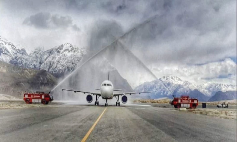 The PIA flight receives a water salute at Skardu Airport on Wednesday. — Dawn