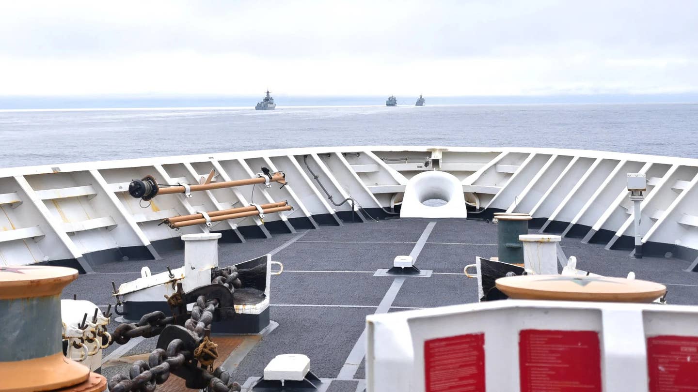 A trio of Chinese warships are seen from the deck of a US Coast Guard ship shadowing them near Alaska's Aleutian Islands as they headed north toward the Arctic Region in 2021. <em>USCG</em>'s Aleutian Islands as they headed north toward the Arctic Region in 2021. <em>USCG</em>