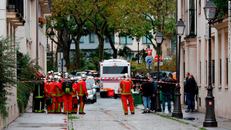 French firefighters are pictured near the scene of a knife attack in Paris on September 25.