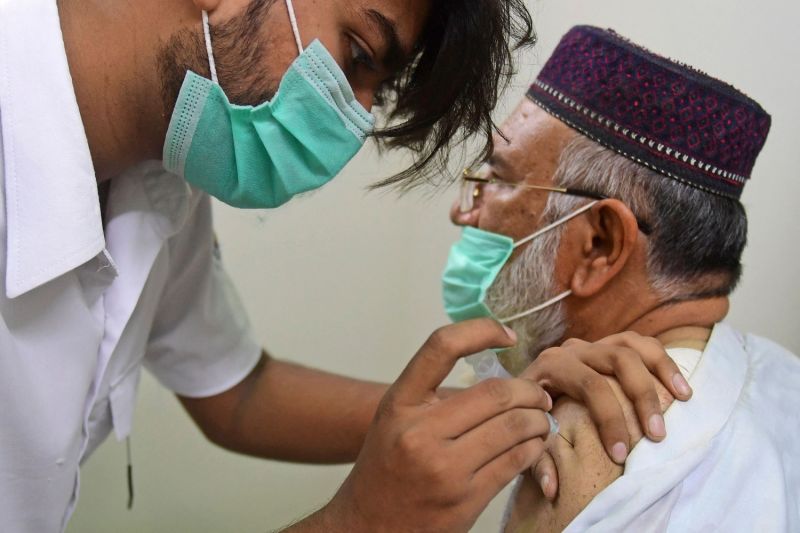 A man receives the coronavirus vaccine in Pakistan.