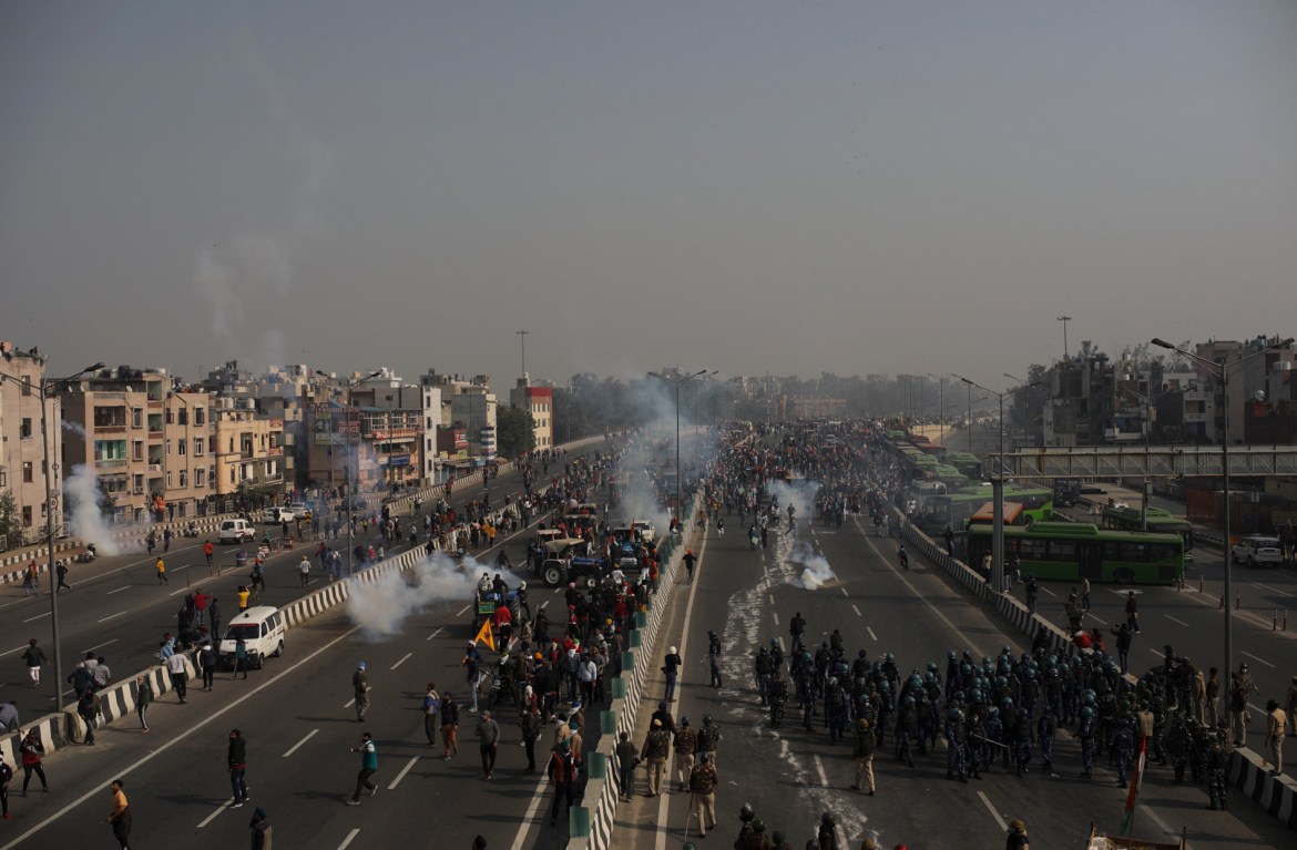 Police use tear gas to disperse farmers who marched to the capital during India's Republic Day celebrations. [Altaf Qadri/AP Photo]