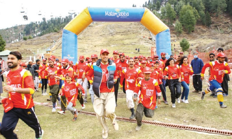 Runners set out from the starting point at the second Swat Marathon at Malam Jabba on Sunday. — Dawn