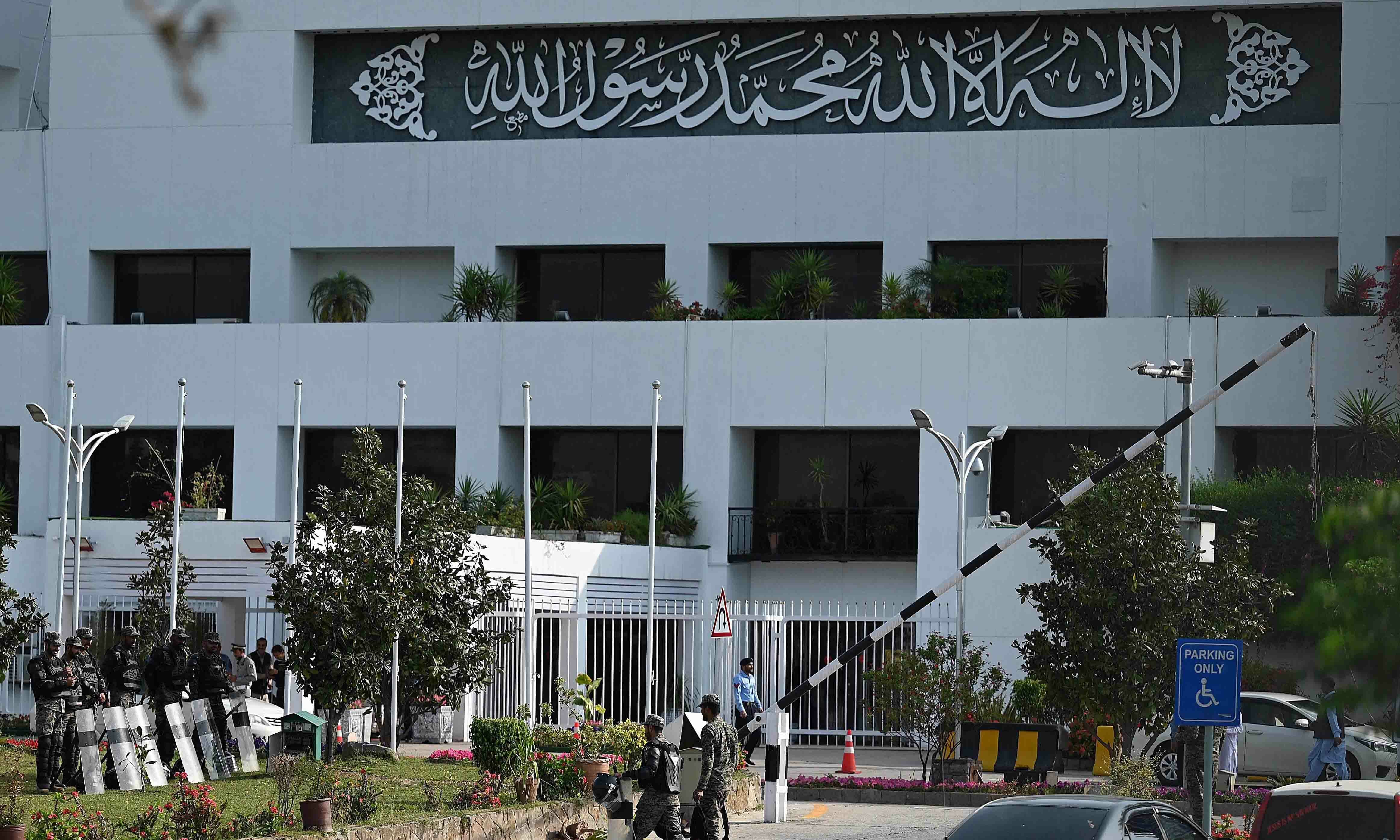 Security personnel arrive to deploy in front of Parliament House building in Islamabad on April 3. — AFP