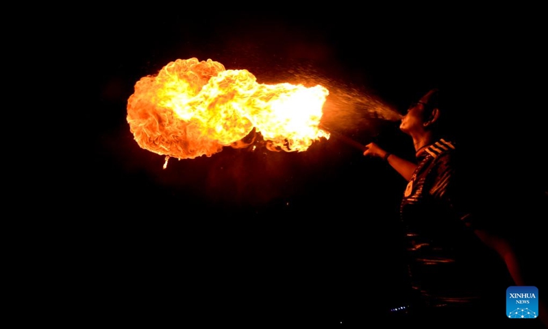 A man performs fire breathing during Sakrain festival in Dhaka, capital of Bangladesh, Jan. 14, 2023. People in Dhaka celebrate Sakrain festival, also known as Ghuri Utsob or Kite festival, at the end of Poush, the ninth month of the Bengali calendar. Photo: Xinhua