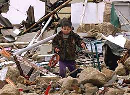 crying-palestinian-child-recovers-homemade-toy-from-demolished-house.rafah.10jan2002.jpg