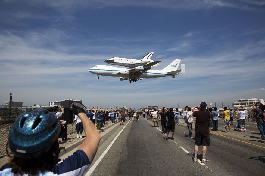 The space shuttle Endeavour, mounted atop a NASA 747 Shuttle Carrier Aircraft lands at Los Angeles International Airport, on Sept. 21, 2012.