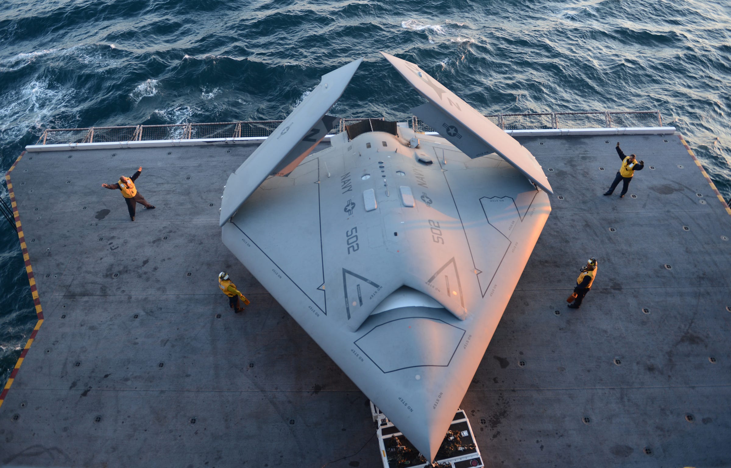 u.s._sailors_move_a_u.s._navy_x-47b_unmanned_combat_air_system_demonstrator_aircraft_onto_an_aircraft_elevator_aboard_the_aircraft_carrier_uss_george_h.w._bush_(cvn_77)_may_14,_2013,_in_the_atlantic_ocean_130514-n-fu443-025.jpg