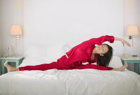 getty_rf_photo_of_woman_stretching_on_bed.jpg.jpg