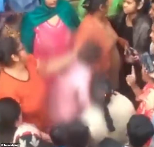 A 20-year-old mother-of-one (centre, in pink) was gang raped and tortured before she was dragged through a crowd in Delhi, India